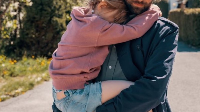 En mann som bærer på et barn.