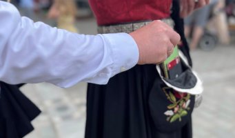 Lommetyv tar mobil ut av en bunadsveske